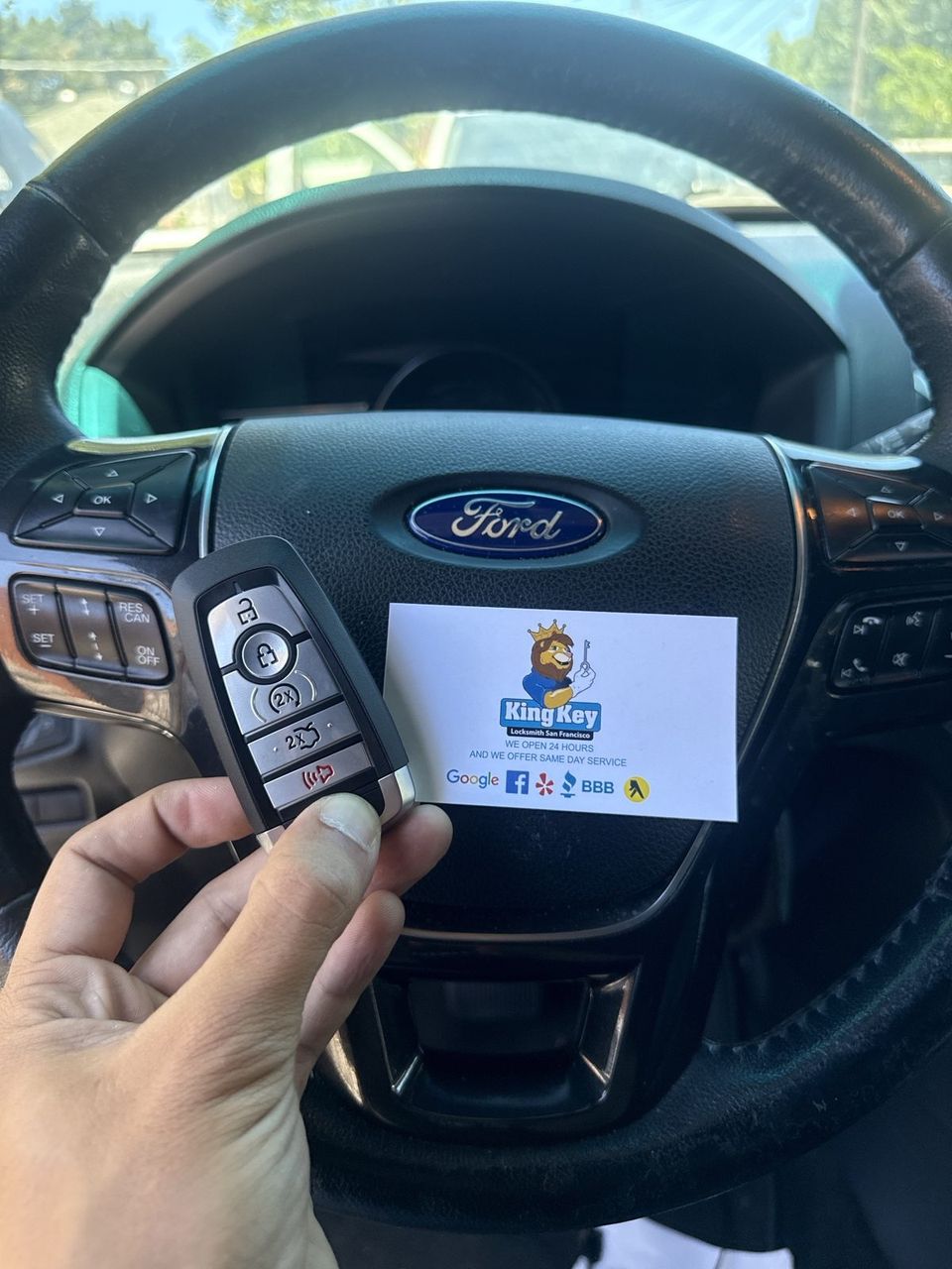 A Ford key being programmed through the car's own port