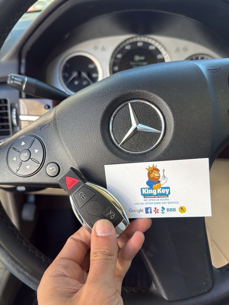 A Mercedes with a newly cut key being programmed at the vehicle